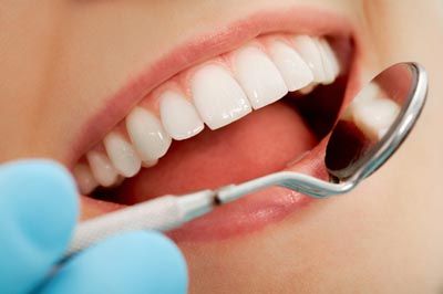 dentist giving a checkup to a patient after using clear teeth aligners